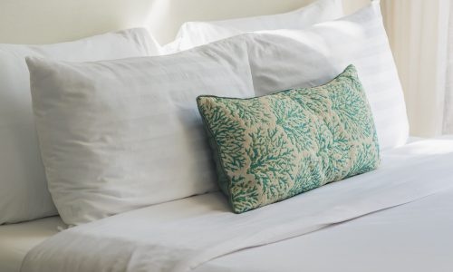 White comfortable pillow on bed decoration interior of bedroom